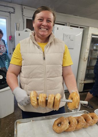 Woman holding fresh donuts